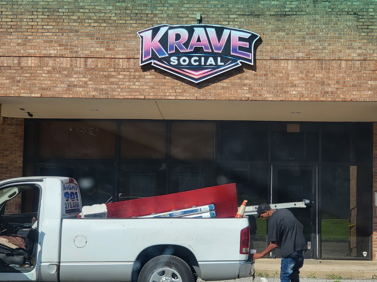 Installed custom Krave Social dimensional storefront sign